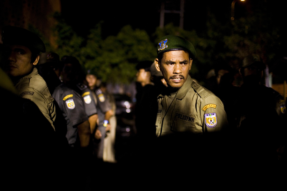 Sharia policemen line up for roll call before a weekly night patrol, in Banda Aceh, Indonesia, on Saturday, Nov. 21, 2009. In 2003, the provincial government of Aceh Province implemented a moderate form of sharia law on conduct and dress in their effort to reclaim Aceh as the Islamic capital of SE Asia. 