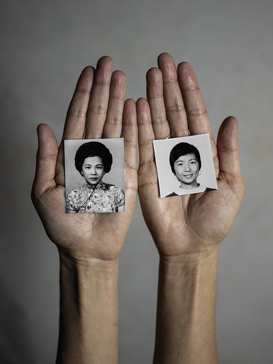 Matriline, 2021. Image size 20x27 inches printed on 24x60 inches Kozo (mulberry paper). Archival Pigment Print.Identification headshots of my grandmother, left, and my mother, right, possibly around the same age, in the palm of my hands gesture as a symbol of respect in Chinese culture.Photography by Lianne Milton