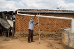 Campo Alegre de Lourdes, Bahia, Brazil. Saturday, Nov. 14, 2015.Pedro Jesus dos Santos, 89, who struggles with his painful glaucoma, holds onto a rainwater pipe as tries to find his way around his home.