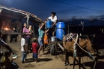 Campo Alegre de Lourdes, Brazil. Saturday, Nov. 14, 2015.A neighbor delivers potable water to Severiana and Pedro’s home in a homestead near Campo Alegre de Lourdes, in Bahia state. Although farming families receive a national anti-poverty cash welfare program, Bolsa Familia, they still suffer from chronic malnutrition, food shortages and limited access to water. The big blue barrel costs $10 Reals, or $2.50 USD.