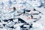 Hunter dragging seals across very poor ice