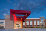 Architectural view of red canopy, entrance to middle school, at dusk. Architectural Photography by Paul Richer / RICHER IMAGES