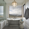 This is an interior photograph which features a bath tub in the master bathroom. The tub is placed up against the window with views of Deer Valley ski resort across the valley.