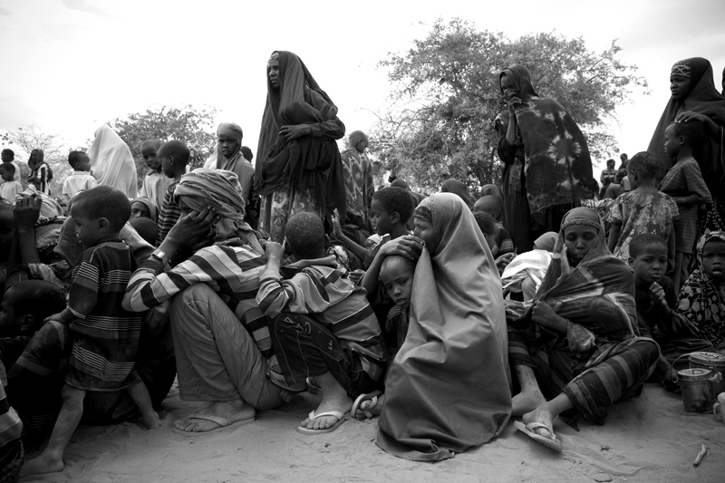 New Somali arrivals gather outside the reception center within Dadaab Refugee Camp. Many arrivals have walked for the past 15 to 30 days to reach the camp.