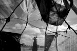 A crude shelter made of sticks, torn cloth and a mosquito net sits on the edge of Ifo Extension within Dadaab Refugee Camp. 