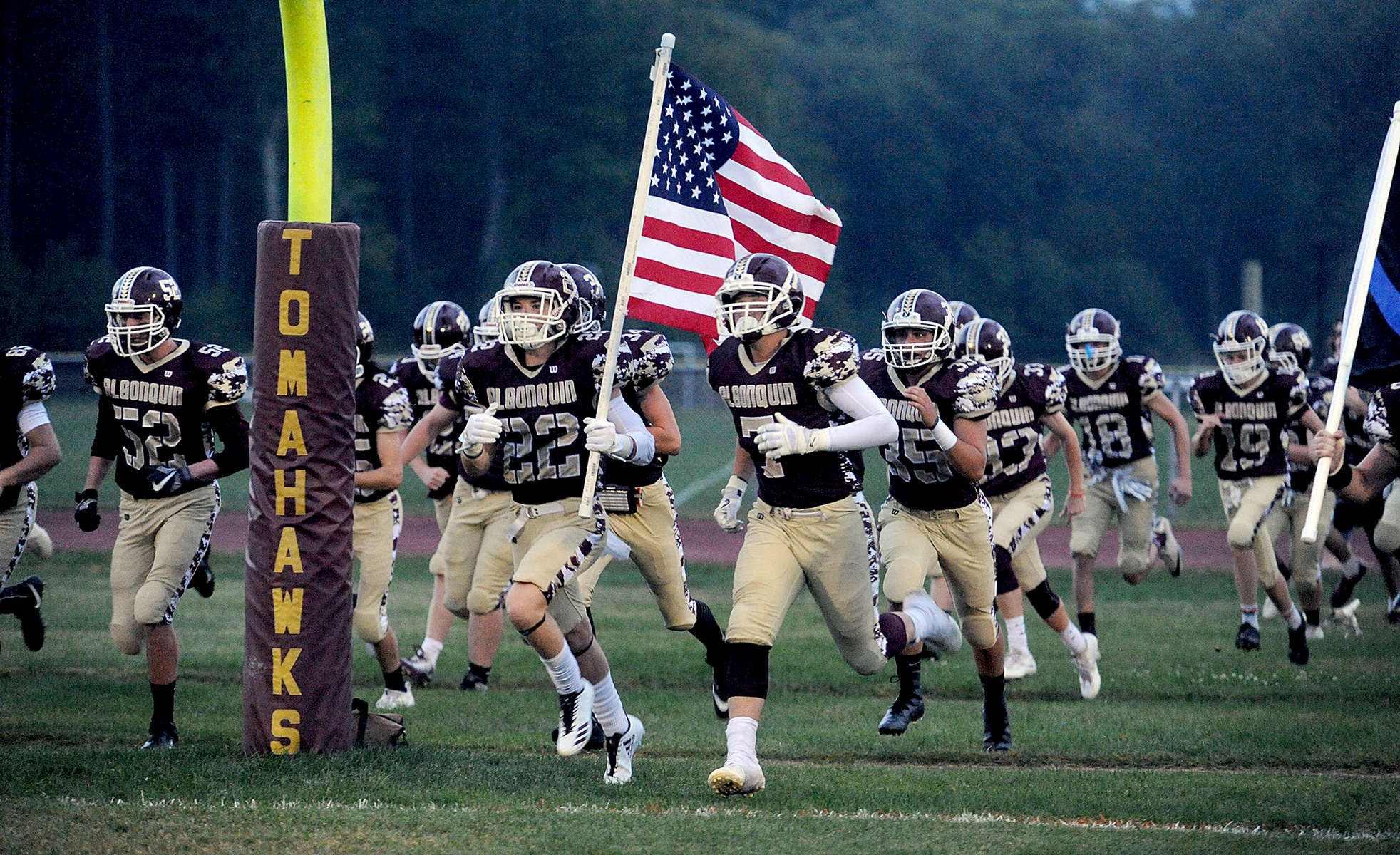 9/15/17-- NORTHBOROUGH--  Algonquin's Zack Smith leads the team onto the field with the American flag Friday night before the game against Marlborough. [Daily News and Wicked Local Staff Photo/Art Illman]