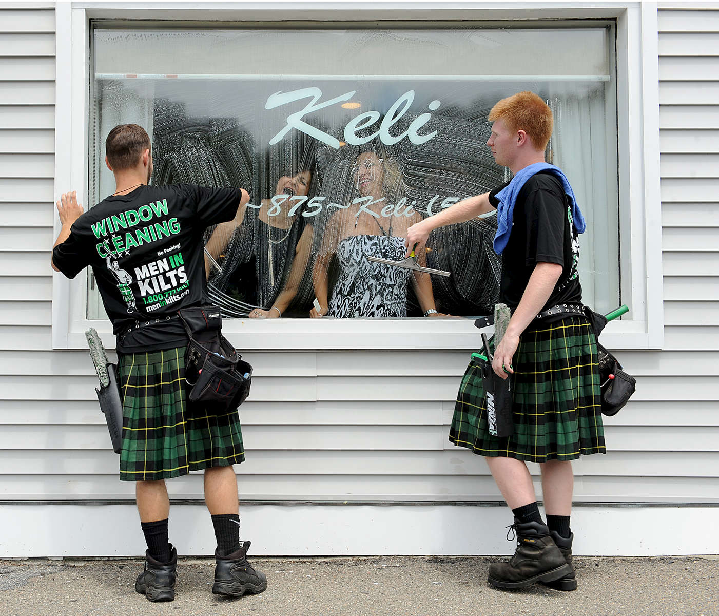 7/7/16-- FRAMINGHAM-- {quote}dressed to kilt{quote}Men in Kilts Window Cleaners Evan Kutz, 20, of Hopkinton, left, and Kyle Booth, 19, of Ashland, seem to meet the approval of hair stylists Natalie Anthony, left, and Cindy Wyman, at Keli in Framingham Centre.Daily News and Wicked Local Staff Photo/Art Illman
