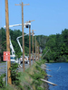 7/23/16  SOUTHBOROUGH-- Crews arrived at 4:30 a.m. Saturday on the Boston Road (Rte.30) causeway to replace utility poles toppled into the Sudbury Reservoir in Friday night's storm.Daily News and Wicked Local Staff Photo/Art Illman