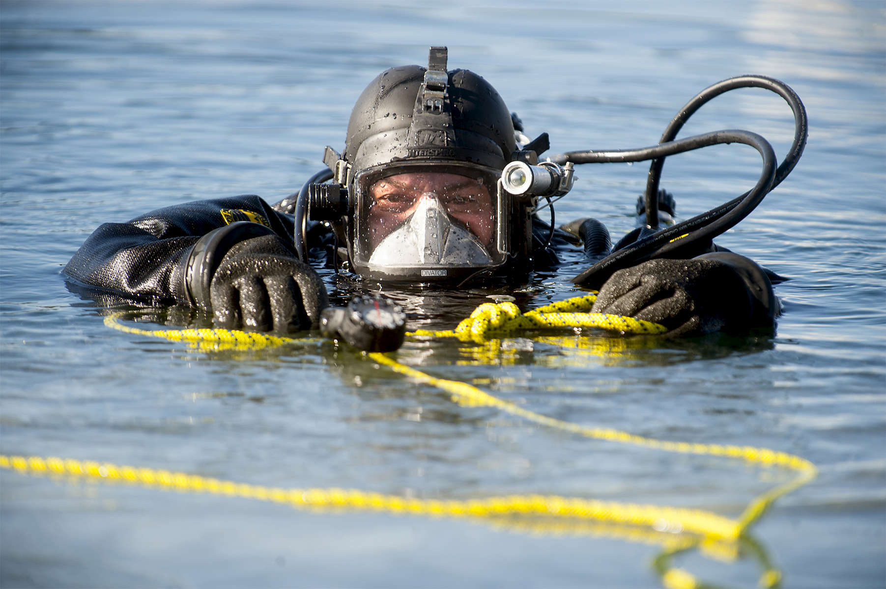 2/6/19-- CONCORD-- Mass. State Police Sgt. Tony Vorias surfaces in the middle of Walden Pond Wednesday.  The State Police Underwater Recovery Unit was conducting ice dive training. The ice was six inches thick.   [Daily News and Wicked Local Staff Photo/Art Illman]