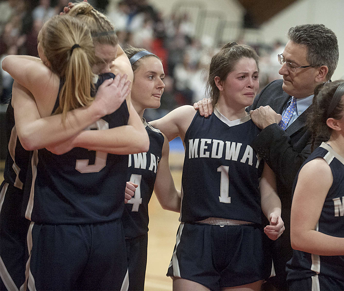 3/5/19-- WORCESTER-- Medway's Rachel Costello (#1) is consoled by coach Joe Iannone after losing to Groton-Dunstable in the Central Mass. Div.2 semi finals Tuesday evening at Clark University. [Daily News and Wicked Local Staff Photo/Art Illman]