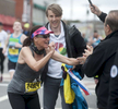 Boston Marathon runner Edna Cibej, of Slovenia, found her family waiting in Framingham: son Vid and husband Jadran. [Daily News and Wicked Local Staff Photo/Art Illman]