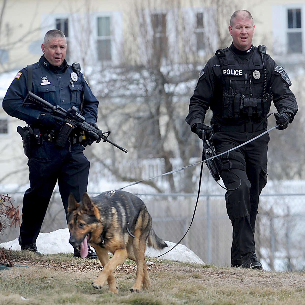 3/21/17-- MARLBOROUGH-- Marlborough Police Officers Robert Bonina, left, and Kenneth McKenzie, and K-9 Kaiser, search for three armed suspects on Lincoln Street Tuesday morning after a reported home invasion.[Daily News and Wicked Local Staff Photo/Art Illman]