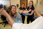 7/28/17-- FRAMINGHAM-- special delivery  EMT Lee Scudo, of Milford, Iman Qureshi, of Wayland, and Julia Pakey, of Wellesley, both UMass students taking the summer EMT program at MassBay Community College, successfully deliver a baby from a “Victoria® Advanced Birthing and Neonatal simulator mannequin” Friday on the Framingham campus. [Daily News and Wicked Local Staff Photo/Art Illman]