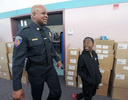 1/22/20-- FRAMINGHAM-- Framingham Police Deputy Chief Lester Baker, here with fifth grader Blessed Tenthani,  was one of five {quote}Bigs in Blue{quote} Big Brothers Big Sisters at the McCarthy Elementary School Wednesday.  The officers ({quote}bigs{quote}) meet with their {quote}littles,{quote}  who all attend the after school program at the MetroWest YMCA,  once a week, for a minimum of one year. So far the students have toured the police station and have other events planned.  Wednesday the students took their Big Brothers Big Sisters on a tour of the school after a pizza lunch. [Daily News and Wicked Local Staff Photo/Art Illman]
