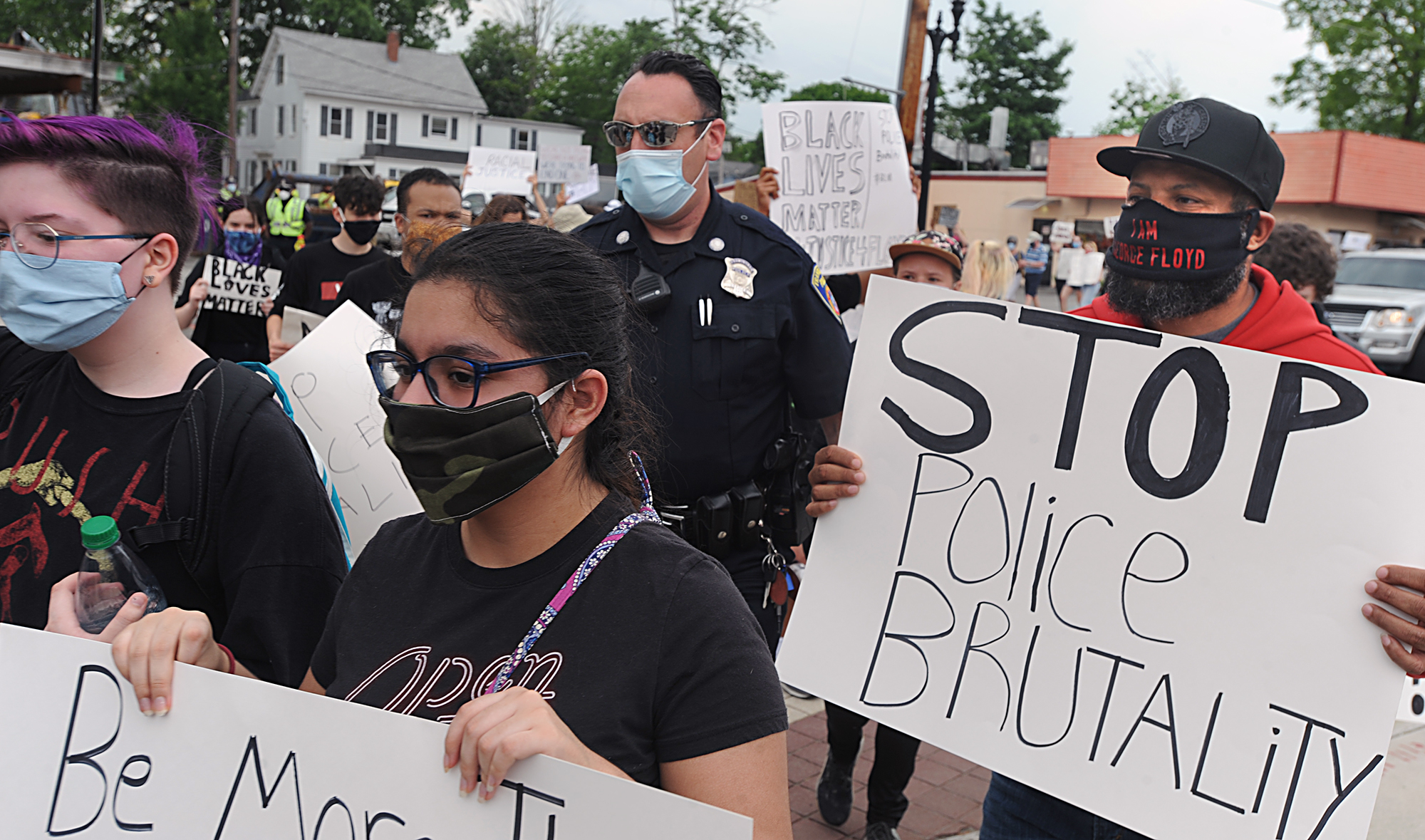 6/3/20-- FRAMINGHAM-- Participants march during a Black Lives Matter rally Wednesday which began at the Framingham Village Green, went to City Hall, and back. Several police officers marched with the group, including School Resource Officer Jay Ball, pictured. [Daily News and Wicked Local Staff Photo/Art Illman]