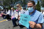 6/12/20-- FRAMINGHAM-- Dr. Lisa Sotir, Framingham Union Hospital emergency department chair, right, joined dozens of MetroWest Medical Center employees for a {quote}White Coats for Black Lives{quote} demonstration Friday in response to the recent events in Minneapolis.  The group kneeled for 8 minutes and 46 seconds, the time George Floyd spent struggling to breathe before he died with a police officer's knee on his neck. [Daily News and wicked Local Staff Photo/Art Illman]