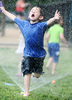 6/18/14--  NATICK--  hot fun in the (almost) summertime--Nathan Churchill, 4, runs through a sprinkler at the Natick Pre School Wednesday at Natick High School.Daily News Staff Photo/Art Illman