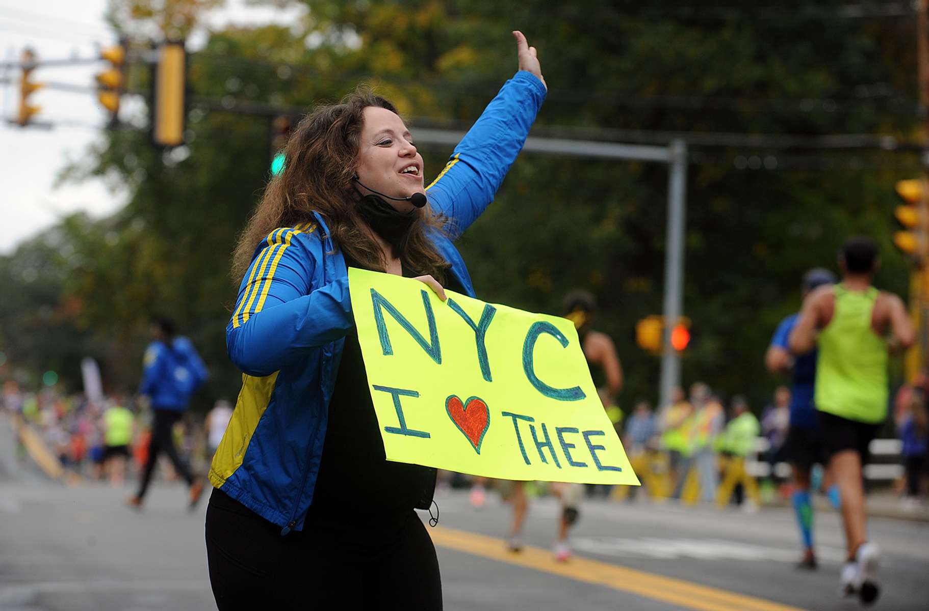 Dana Shulman, of New York, cheers on runners in Natick during the running of the 125th Boston Marathon, Oct. 11, 2021.