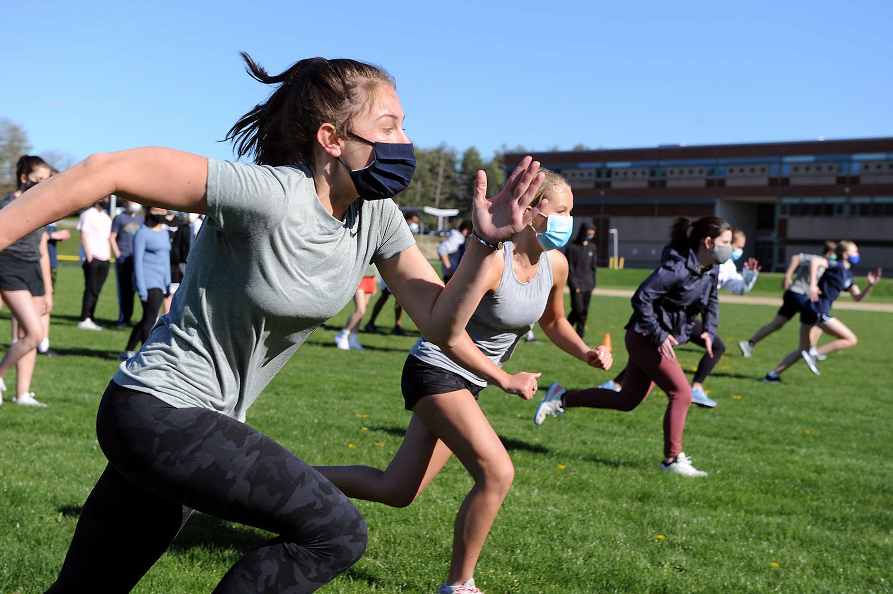 Lincoln-Sudbury Regional High School track team freshmen Katie Drew, left, and Amber Stubblebine run sprints on the first day of spring practice, April 26, 2021.