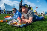 Brian Bumgarner, of New Jerey, formerly of Natick, left, and David Szostak, of New Jersey,  on the grass at the Athlete's Village at Hopkinton High School  before the 128th running of the Boston Marathon, April 15, 2024.