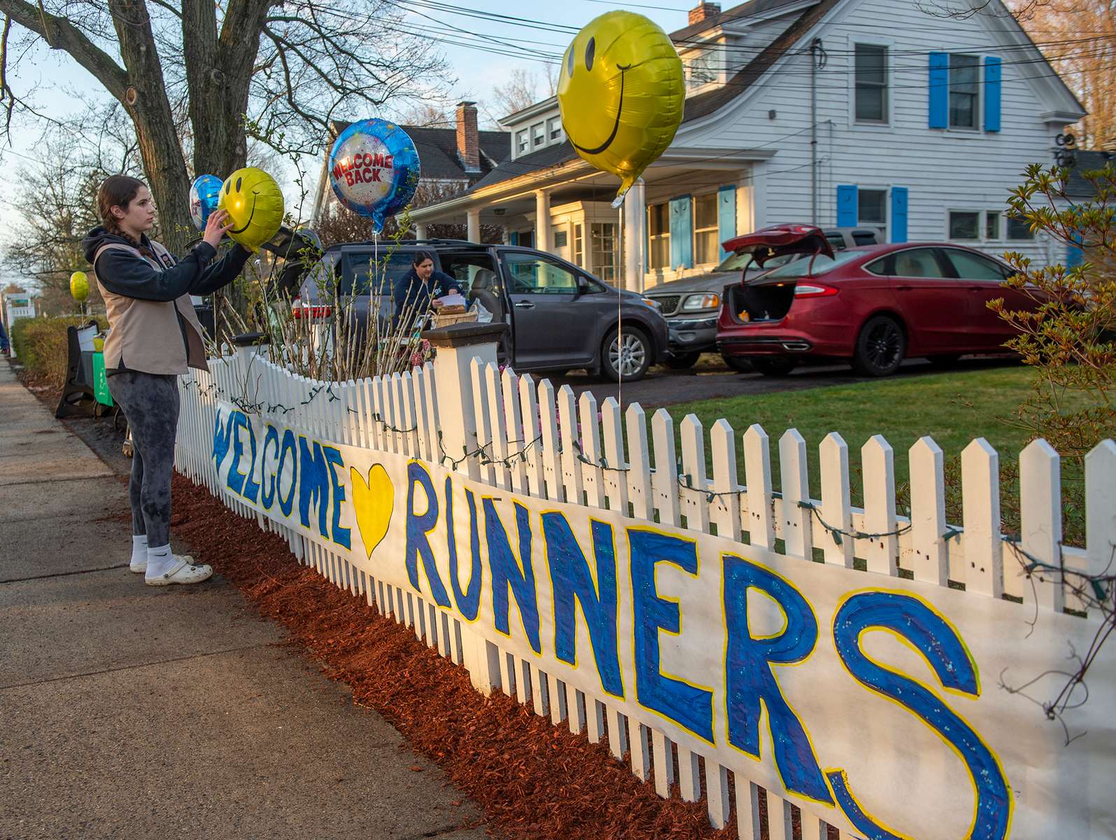 Isabella Gill, of Girl Scout Tropp 62495 in Hopkinton, raising money for a professional grade gaga ball pit at EMC Park,  adjusts balloons before the 128th running of the Boston Marathon in Hopkinton, April 15, 2024.