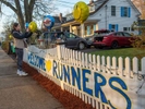 Isabella Gill, of Girl Scout Tropp 62495 in Hopkinton, raising money for a professional grade gaga ball pit at EMC Park,  adjusts balloons before the 128th running of the Boston Marathon in Hopkinton, April 15, 2024.