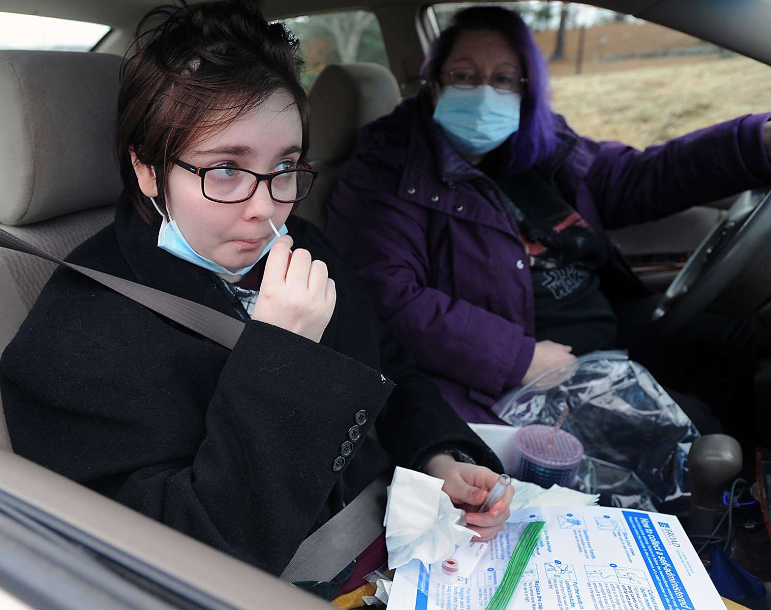 Caitlyn O’Leary, of Maynard, takes a COVID-19 test at the Mass. Dept. of Public Health Stop the Spread testing site, run by the Marlborough Hospital, at the Marlborough Sports Center, Jan. 3, 2022. 