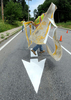 7/9/14-- NATICK--  Natick Department of Public Works employee Paul Holmgren pulls away a stencil during line painting Thursday on Hartford Street.  He also sprinkled glass beads on the wet paint which provides a reflection at night, he said.Daily News Staff Photo/Art Illman