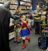 7/23/14-- SOUTHBOROUGH--  At The Hall of Comics in Southborough, (Wonder Woman) Harley Davis, 5, of Hudson, high fives Batman, (Spencer Doe), at Batman Day at the new comic book store. Dozens of fans turned out to celebrate Batman's 75th birthday and to meet Robin, Batgirl, and Nightwing.Daily News Staff Photo/Art Illman