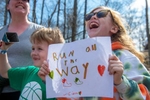 Ciara Lindquist, 9, and her brother, Ian, 6, of Hopkinton, cheer on runners at start of the 128th running of the Boston Marathon in Hopkinton, April 15, 2024.