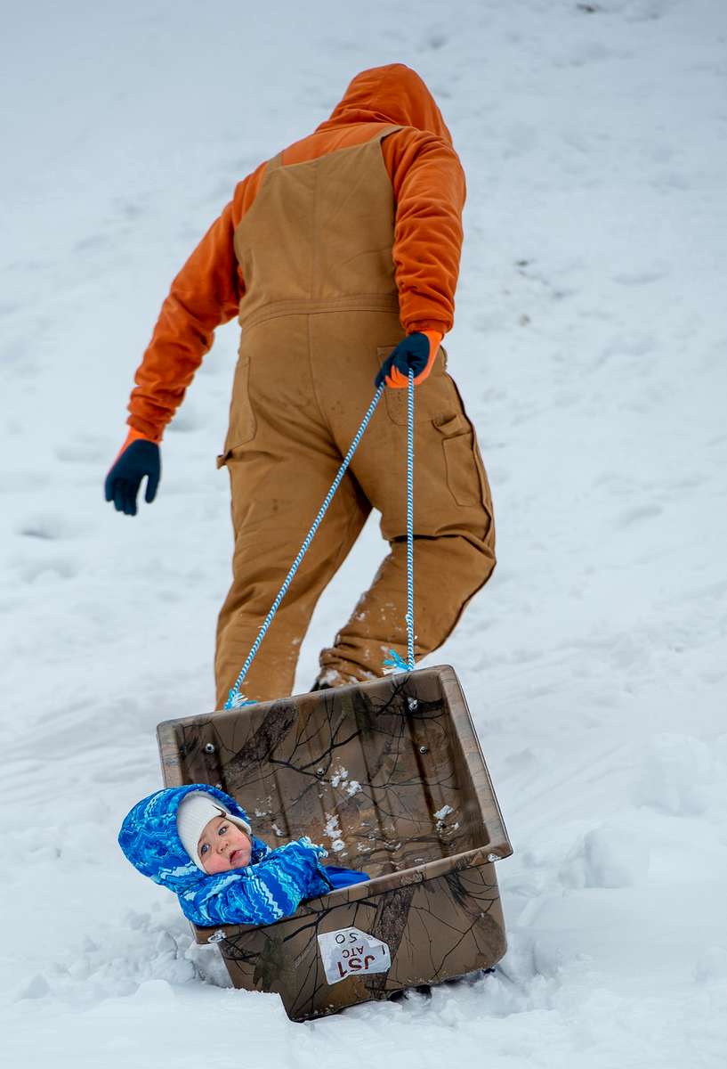 Charlotte Lutes, 19-months-old, gets a lift from dad Allan at Ward Park in Marlborough, Jan. 24, 2023.