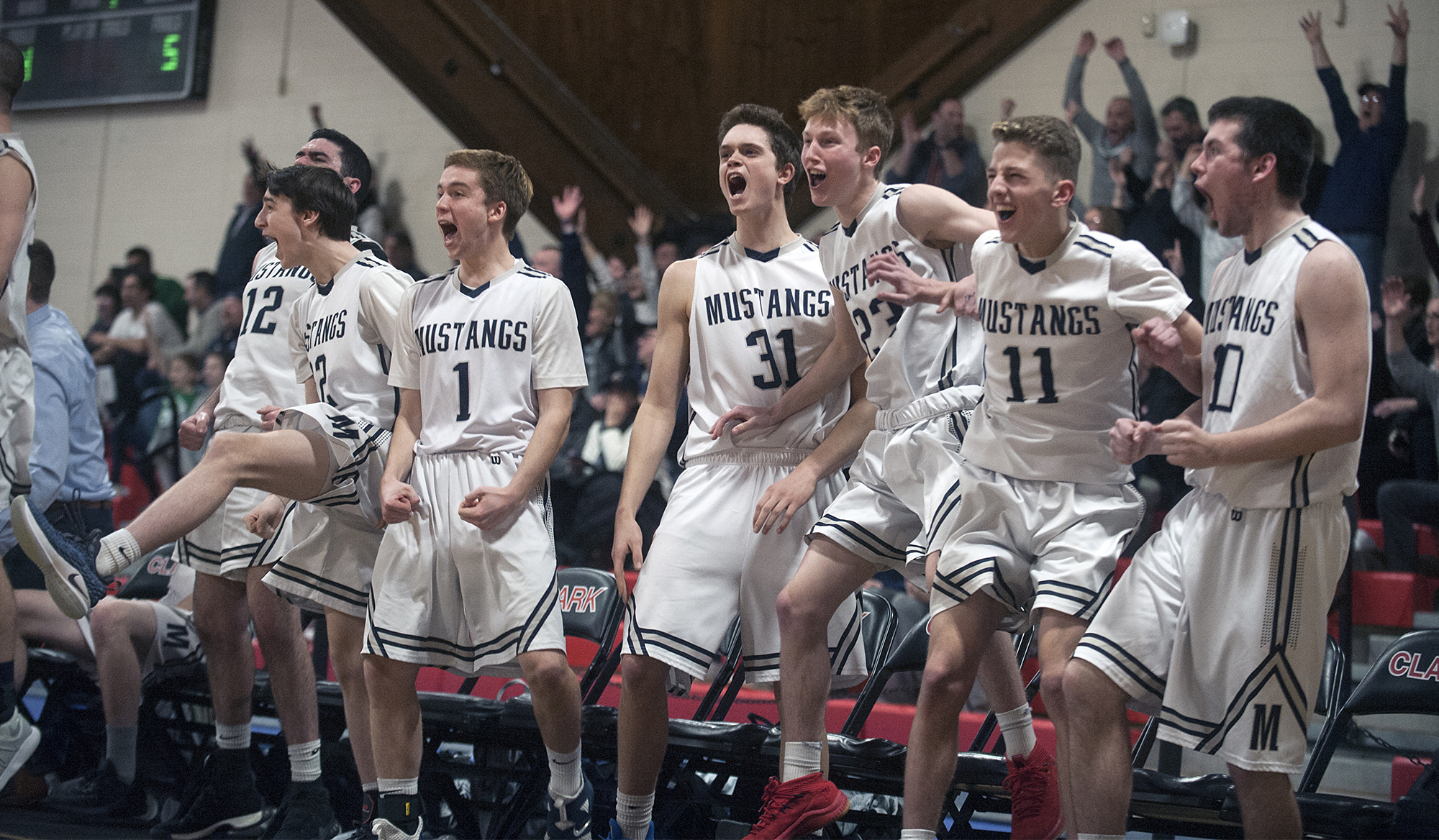 3/5/19-- WORCESTER-- Medway's bench erupts after Kyle Regan hit a three-pointer in the fourth quarter against Groton-Dunstable.  The Mustangs won 52-43 in the Central Mass. Div.2 semi finals Tuesday evening at Clark University. [Daily News and Wicked Local Staff Photo/Art Illman]