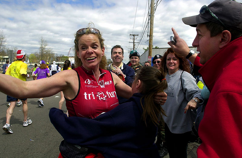 In 2006,  runner Lisa Hodge of Wilmington meets up with family  near downtown  Framingham.