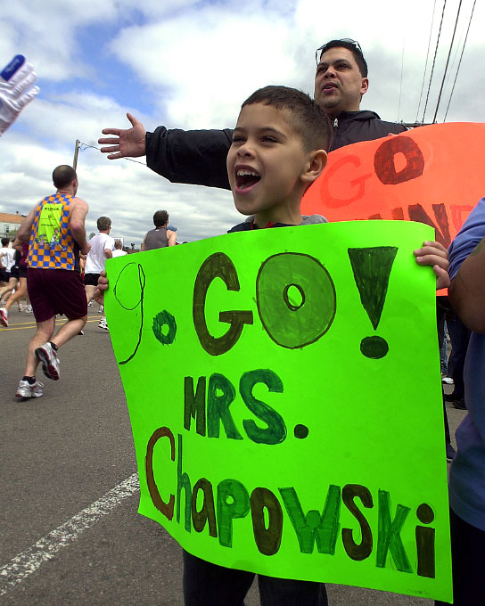 In 2006, Daniel Vazquez, 7, of Framingham, cheers for his Dunning School teacher  Mrs. Chapowski.  Behind him is his dad, Orlando.