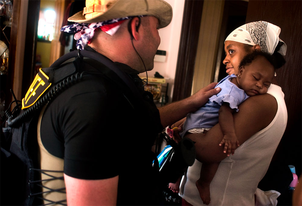 After 45 minutes of negotiations, 10 people of the extended Robinson family agree to leave their home in New Orleans. Although no water had come into their living area, street level was at least 5 feet under water. Deputy Nate Lerner, proceeds to inquire about the health of a mother's 4-month-old baby who appeared to be faring well.