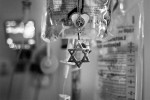 Pepa hangs Mooda's necklace from the IV post in the hospital room. A Rabbi made regular visits to the family there.
