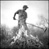 Chris Tyler performs his annual chore of removing and burning dry brush from a stretch of the Santa Ana Acequia that runs along his property in Algodones, N.M.