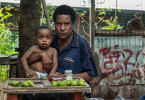 Betel nut seller Nancy Wala at Eight Mile with her child Teffynaya.  © Brian Cassey