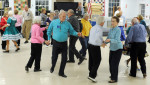 The Nau-sets square dancing club gets three squares moving on a Tuesday night at the Dennis Senior Center. Four couples make a square and dances in patterns designed by the caller.