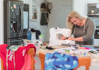 FORESTDALE -  Lauren Neidigh, owner of the apparel line Cape Camo, disassembles her unsold inventory and is turning the fabric into protective masks for healthcare workers at nursing facilities on Thursday, March 26, 2020.