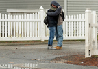 HYANNIS - Robert Walker and Megan Joseph share an embrace to stay warm while waiting for emergency shelter St. Jospeh House to open on Monday, March 30, 2020. The Barnstable County Department of Human Services is working with other area nonprofits to accommodate shelter overflow during the pandemic.