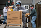 HYANNIS - Town golf course employees brave the wind and rain to bring in a food delivery to the Adult Community Center on Friday, April 3, 2020. The crew was tasked with putting together 240 bags of food to be delivered to seniors.