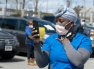 HYANNIS - A healthcare worker appears moved as she shoots video of the well-wishers in the Cape Cod Hospital parking lot on Friday, April 10, 2020. 