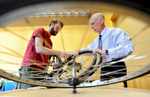 Worcester Earn a Bike volunteer Matt Warndorf, left, shows Dr. Joel Gore how to fix a flat during the 10th annual Earth Day celebration at UMASS Medical School on Wednesday, April 22, 2015. Gore said he wanted to learn because his wife always fixes his flats.