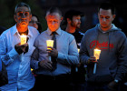 From left, Raymond Bastille of Falmouth, Kristoph Pydynkowski of Buzzards Bay and Mike Tallia of Falmouth, who are all in recovery, hold candles during the third annual overdose vigil on the Hyannis Village Green on Sunday, September 22, 2014. Pydynkowski was the keynote speaker at the vigil. He shared his story of battling heroin addition. He is now an intervention and recovery specialist at Gosnold where he was treated.