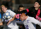 Douglas goalkeeper Daniel Hayes punches the ball away from Norton players Daniel Pereira and Matthew Loranger in the Division III state final on Saturday, Nov. 21, 2015. 