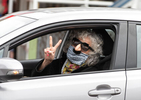 PROVINCETOWN - Canteen customer Corinne Sirna flashes a peace sign after picking up her grocery order on Tuesday, April 21, 2020. Anderson and Rossignon have received over $11,000 in donations to go toward free grocery orders for those who need assistance. 