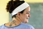 RN Lori Belliveau of Fitchburg shows off her Forward in Health tattoo during a pop-up clinic at the Ecole Presbyteral de Dantan on Wednesday, November 2, 2016. She is on her third trip with FIH and is leading another one in February.
