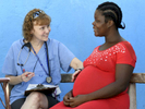 RN Paula Mulqueen, the Forward in Health trip director, speaks with a woman who is 7-months pregnant during a pop-up clinic at the Ecole Presbyteral de Dantan on Wednesday, November 2, 2016. 