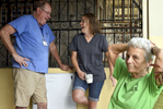Dr. John Harrington of Gardner, the designated jokester on the trip, cracks up RN Lyndsay Funk with a humorous story with RN Doris Forte relaxes on the porch of the mission house on Saturday, November 5, 2016. 